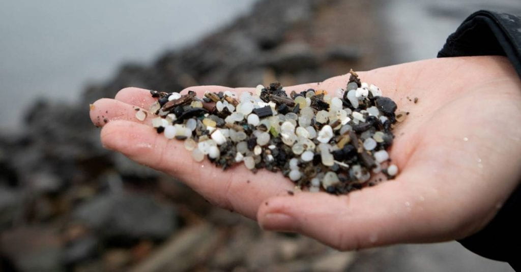 Plastic pellets mixed with sand on a New Zealand beach. Image credit: Thomas Manch/Stuff.