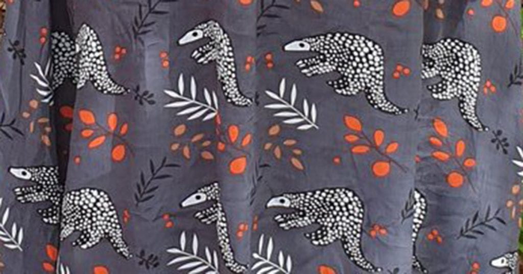 Fabric print with red flowers and pangolins
