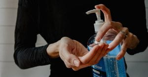 Woman using hand sanitiser