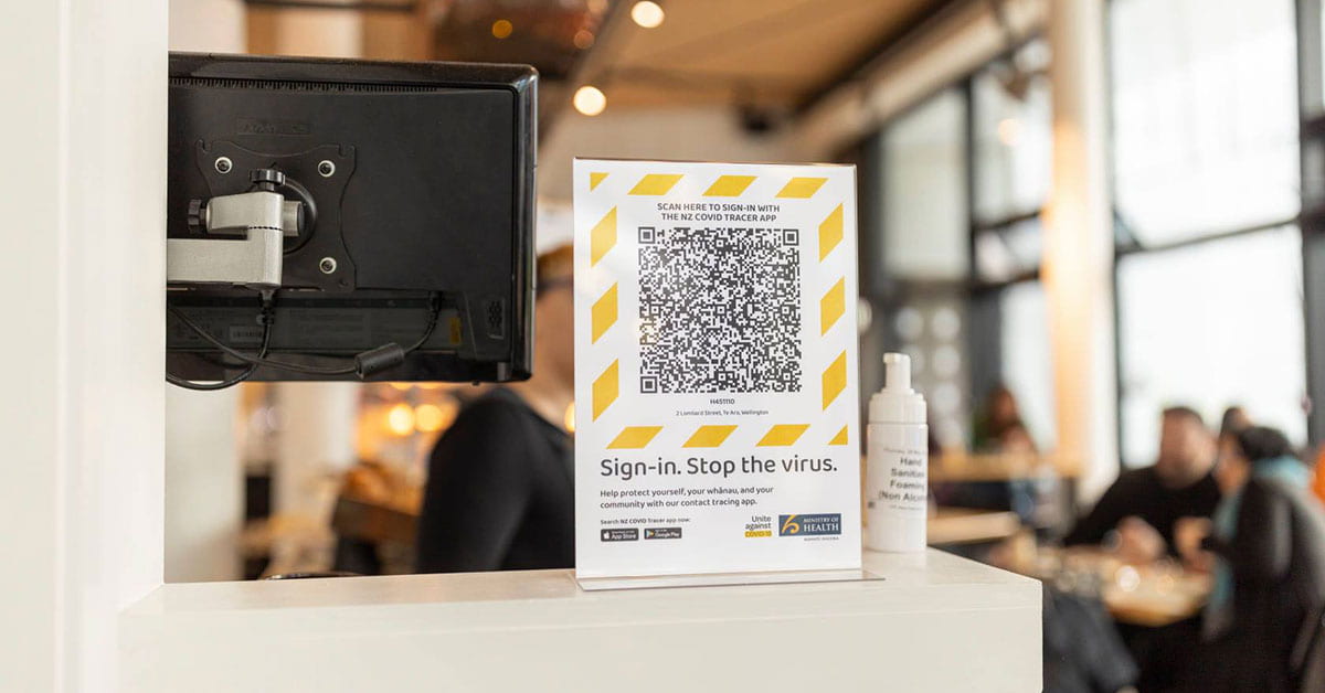 A COVID tracer QR code print out in a cafe