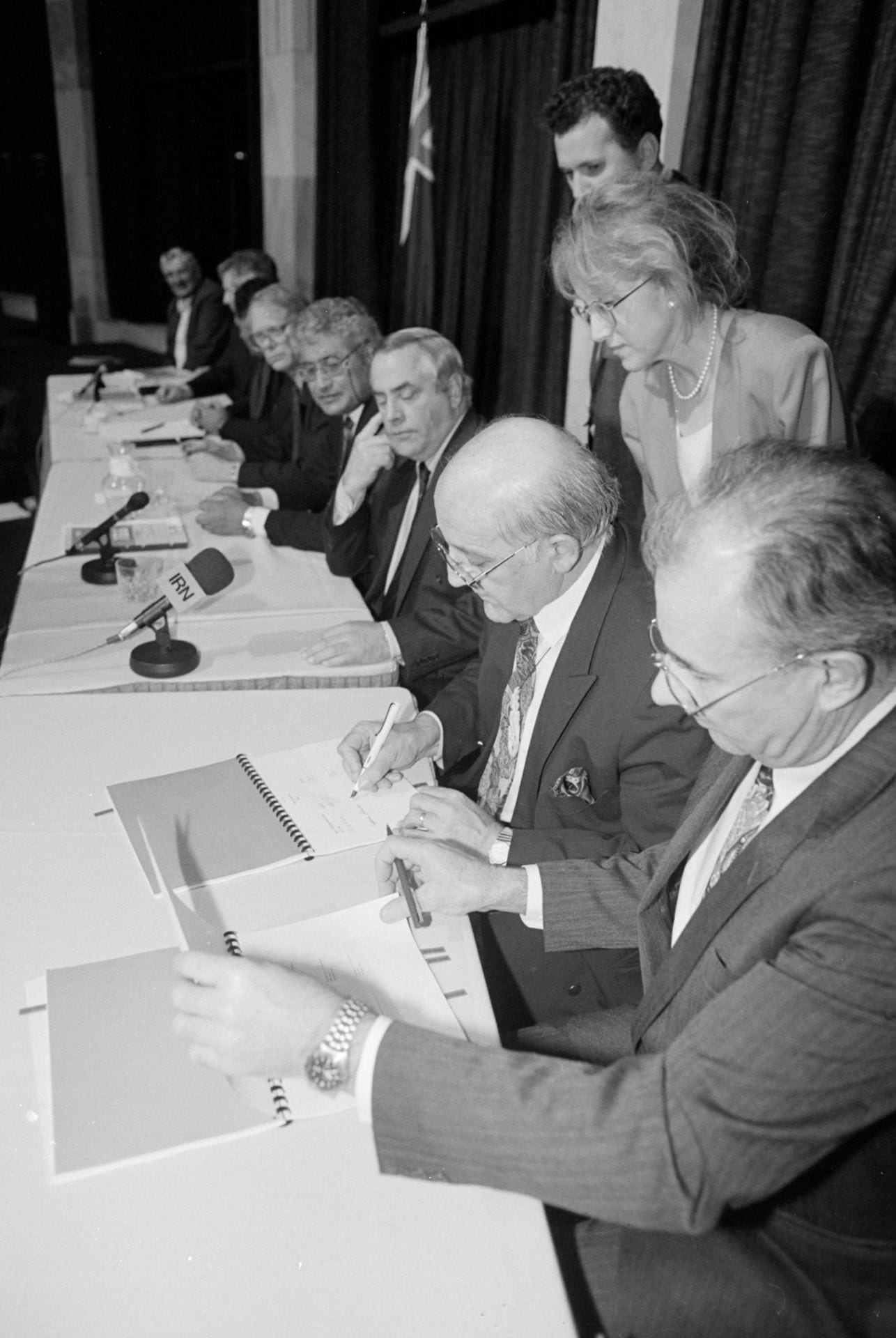 The signing of the Māori Fisheries Settlement 1992. From right: Sir Don McKinnon, Tā Tipene O'Regan, Sir Douglas Graham and others involved in negotiations. Image credit: Michael Smith, Dominion Post Collection, National Library of New Zealand Te Puna Mātauranga o Aotearoa, Alexander Turnbull Library, Wellington.