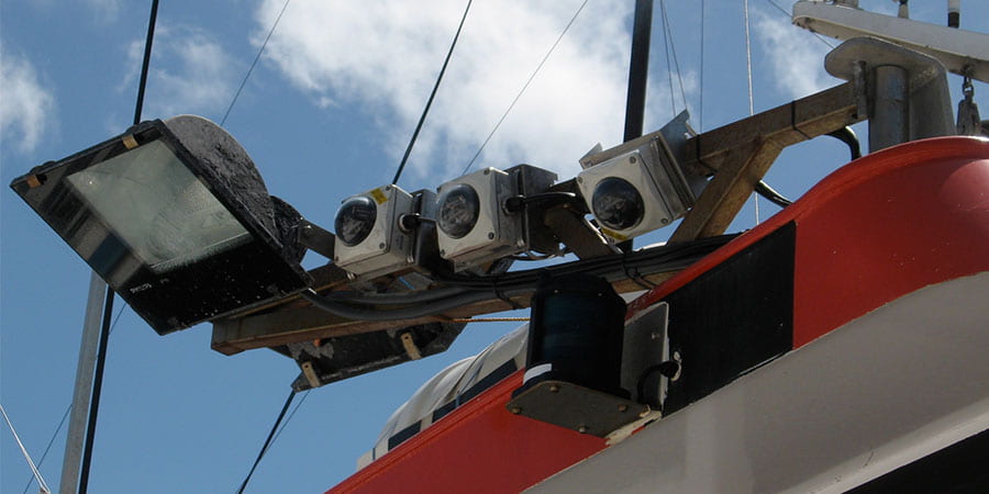 Three cameras mounted on a fishing vessels oriented in slightly different directions